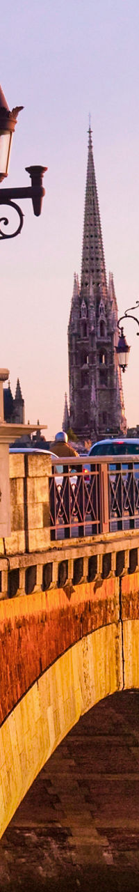 Historic stone bridge at sunset in Bordeaux