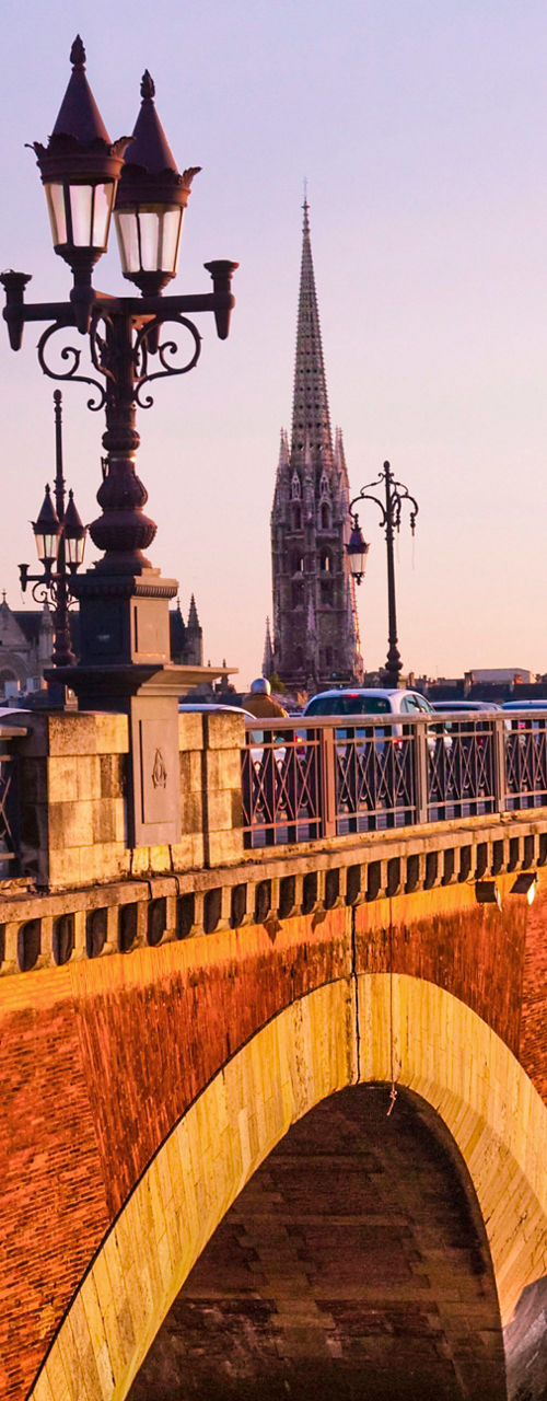 Historic stone bridge at sunset in Bordeaux