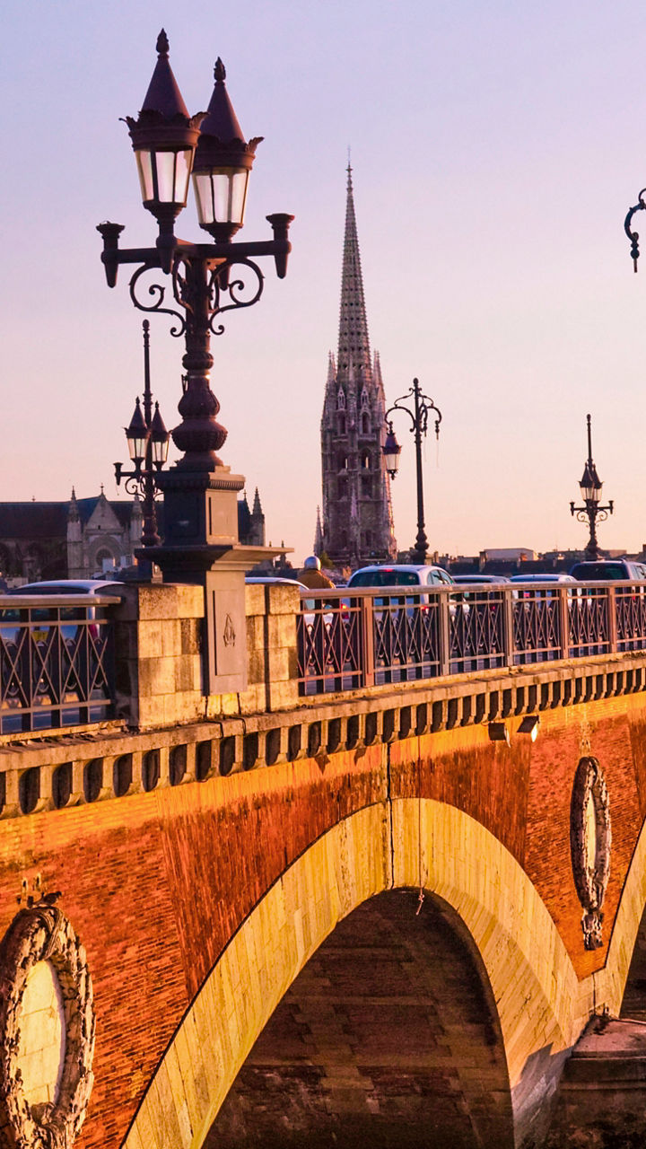 Historic stone bridge at sunset in Bordeaux