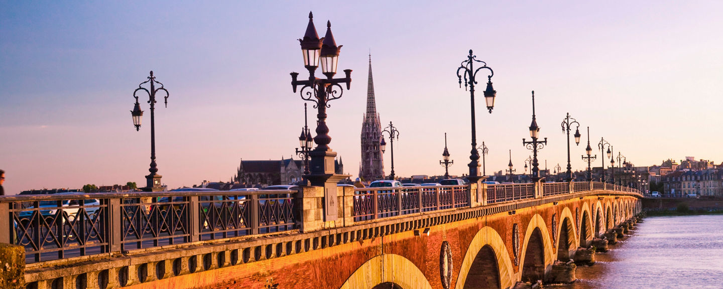 Historic stone bridge at sunset in Bordeaux