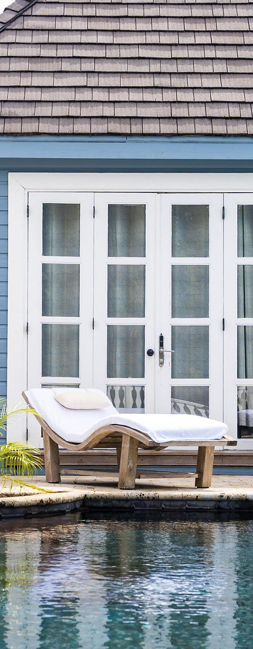 Luxury poolside cottage with lounge chairs