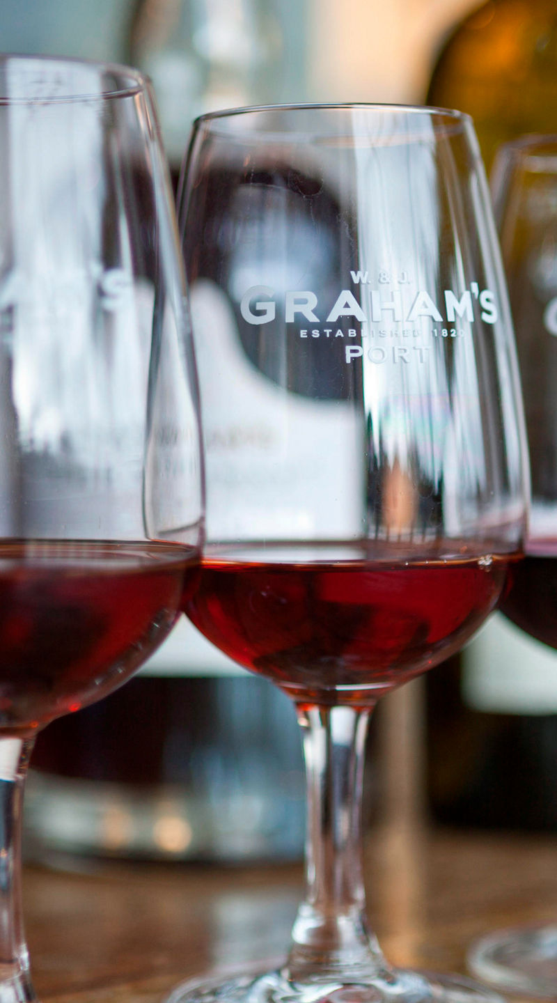 Three wine glasses with red wine on table