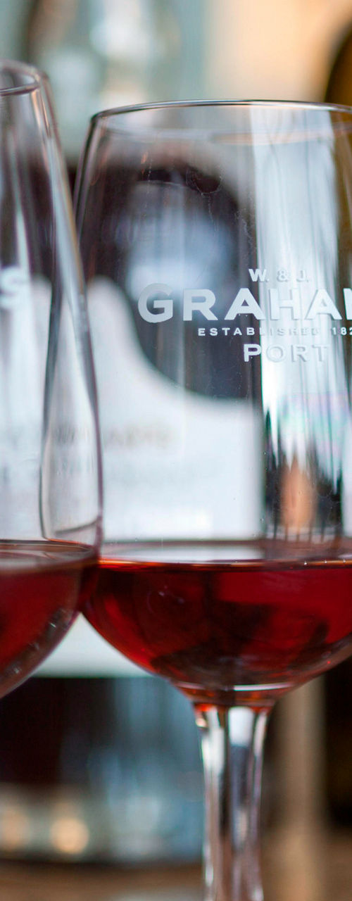 Three wine glasses with red wine on table