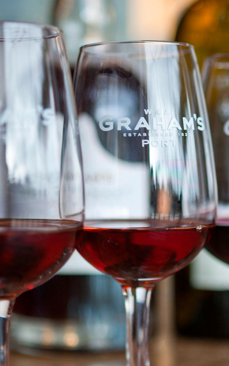 Three wine glasses with red wine on table