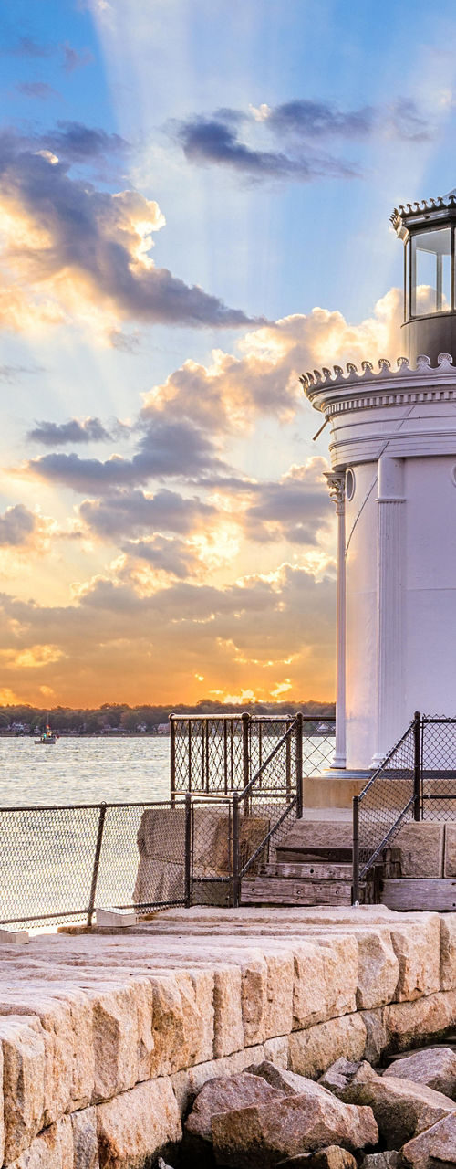 Scenic lighthouse at sunset by the sea