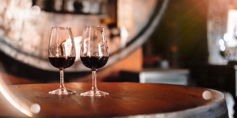 Two glasses of red wine on barrel