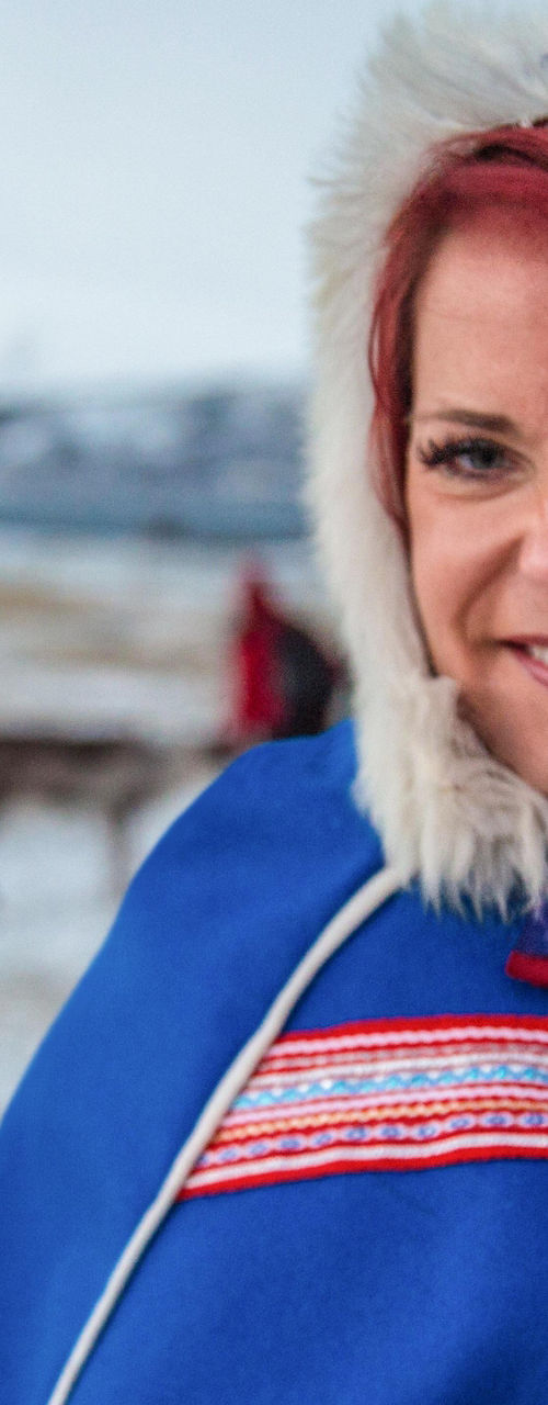 Person in traditional attire with reindeer