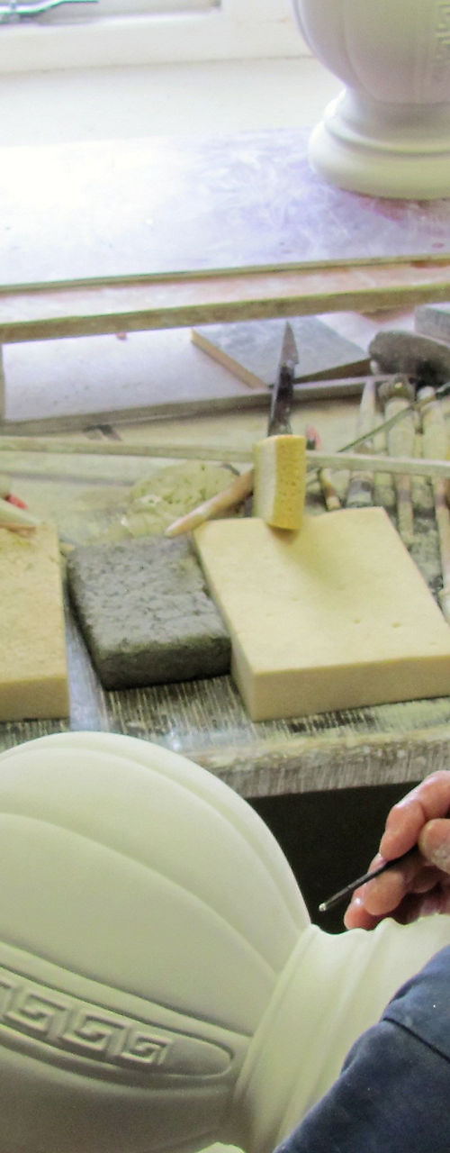 Artisan crafting ceramic vase in workshop