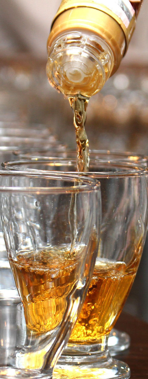 Pouring whiskey into clear glassware