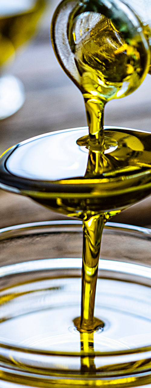 Pouring olive oil into glass bowl