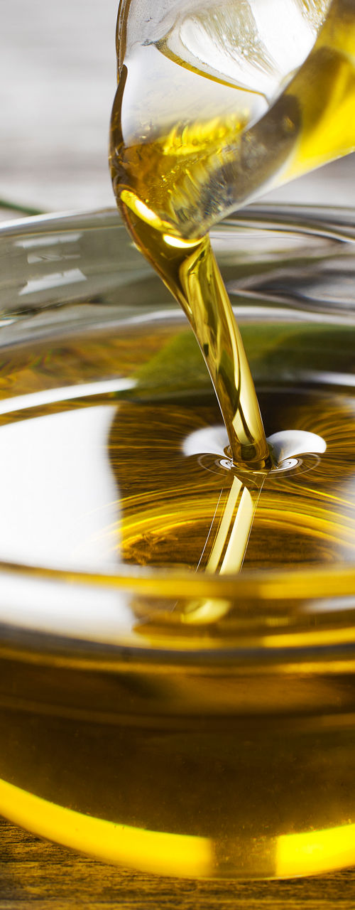 Pouring olive oil into glass bowl
