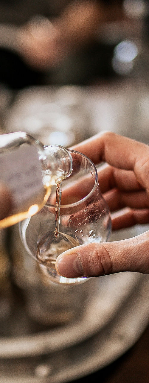 Pouring drink in casual social gathering
