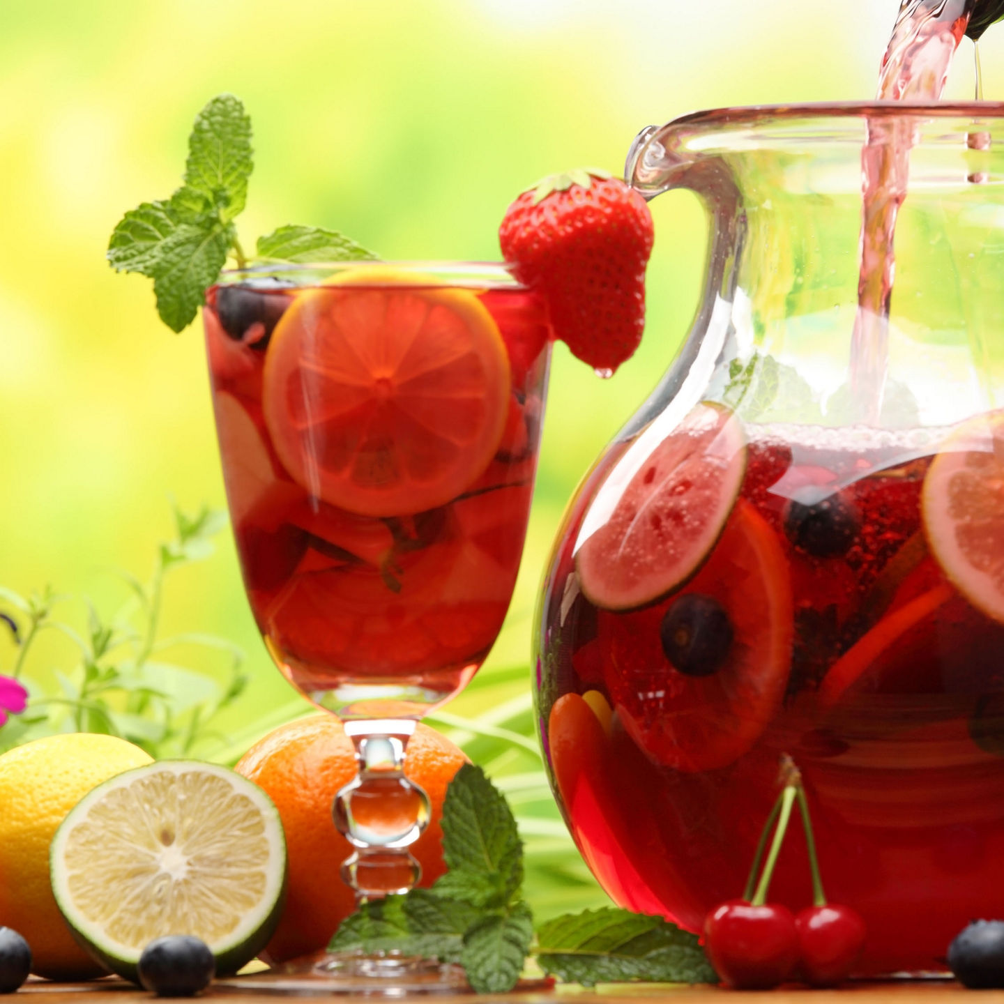 Refreshing fruit punch in glass and pitcher