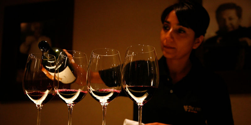 Wine pouring into four glasses