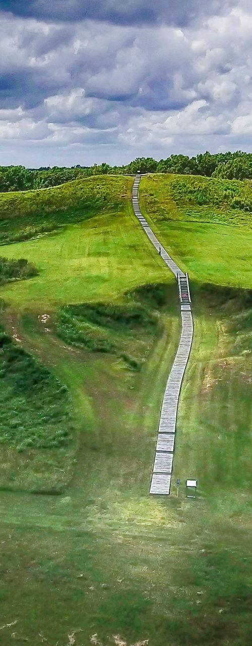 Scenic view of ancient grassy mound