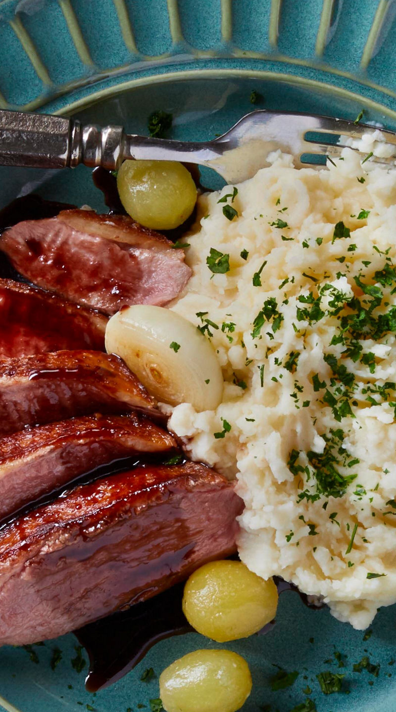 Plated steak with mashed potatoes and wine
