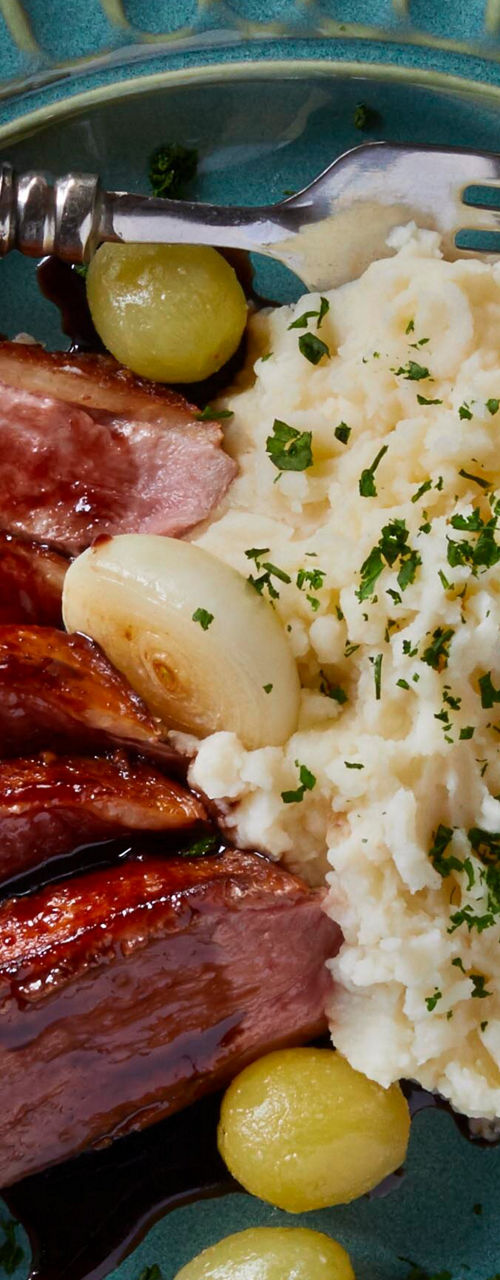 Plated steak with mashed potatoes and wine
