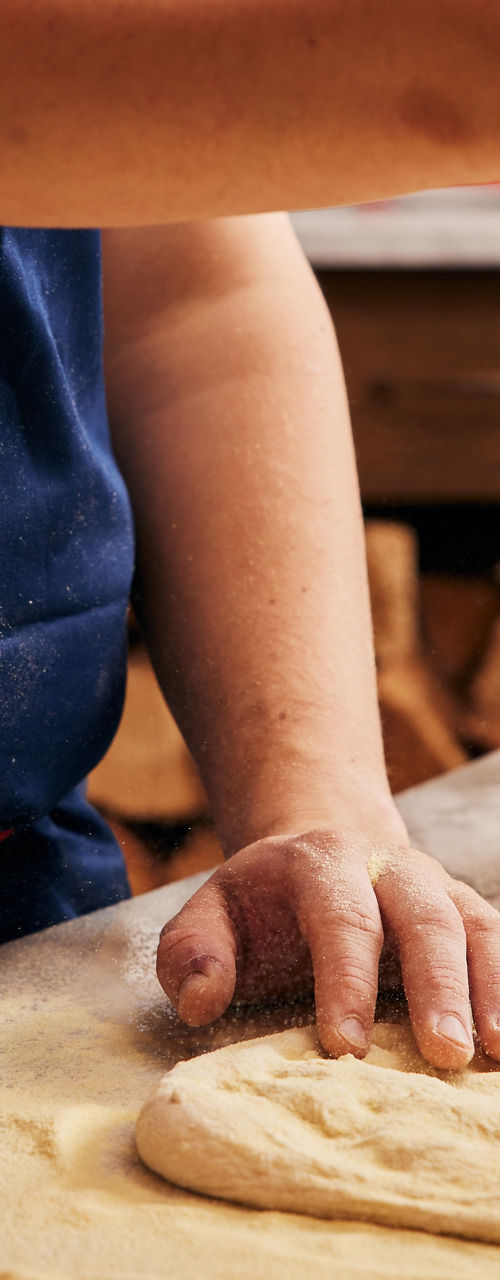 Chef Sprinkling Flour Over Pizza Dough