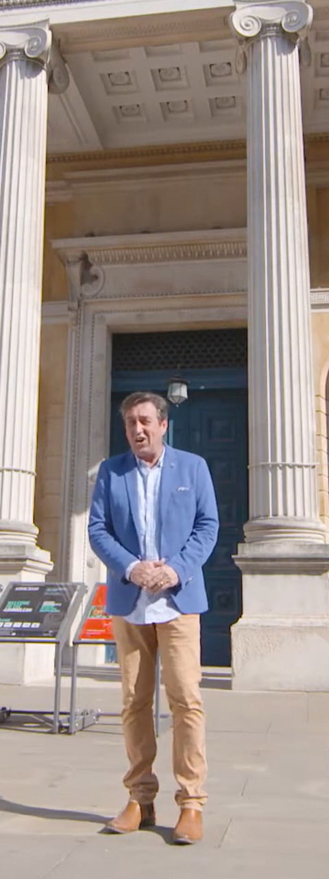 Man standing outside museum with Pompeii banners