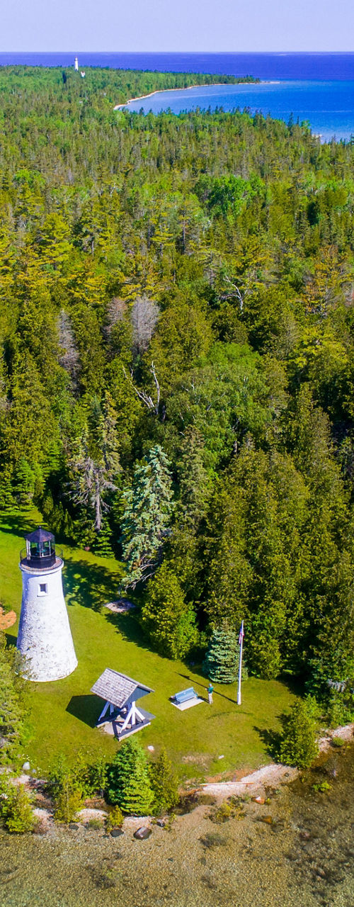 Scenic lighthouse on lush island coast