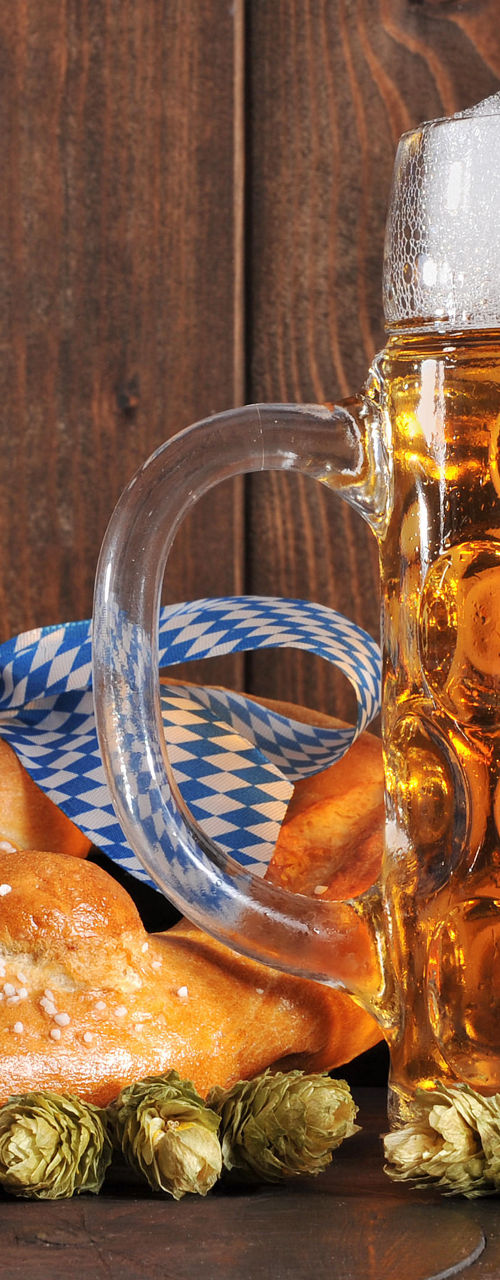 Beer mug with pretzel on wooden table