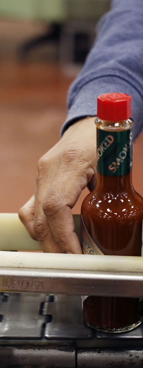 Hot sauce bottles on factory conveyor