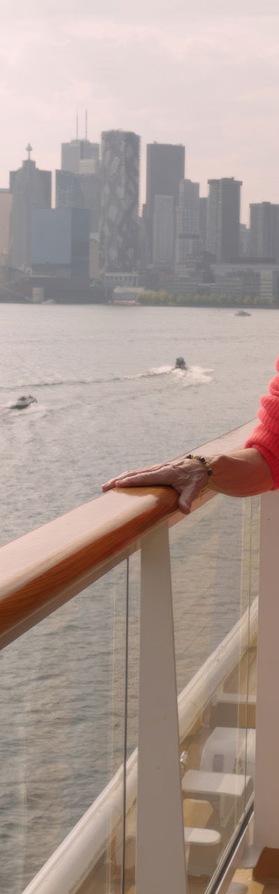 Woman on cruise ship with city skyline