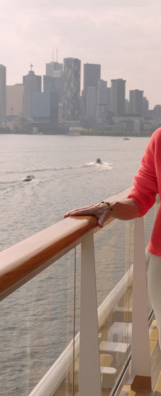 Woman on cruise ship with city skyline