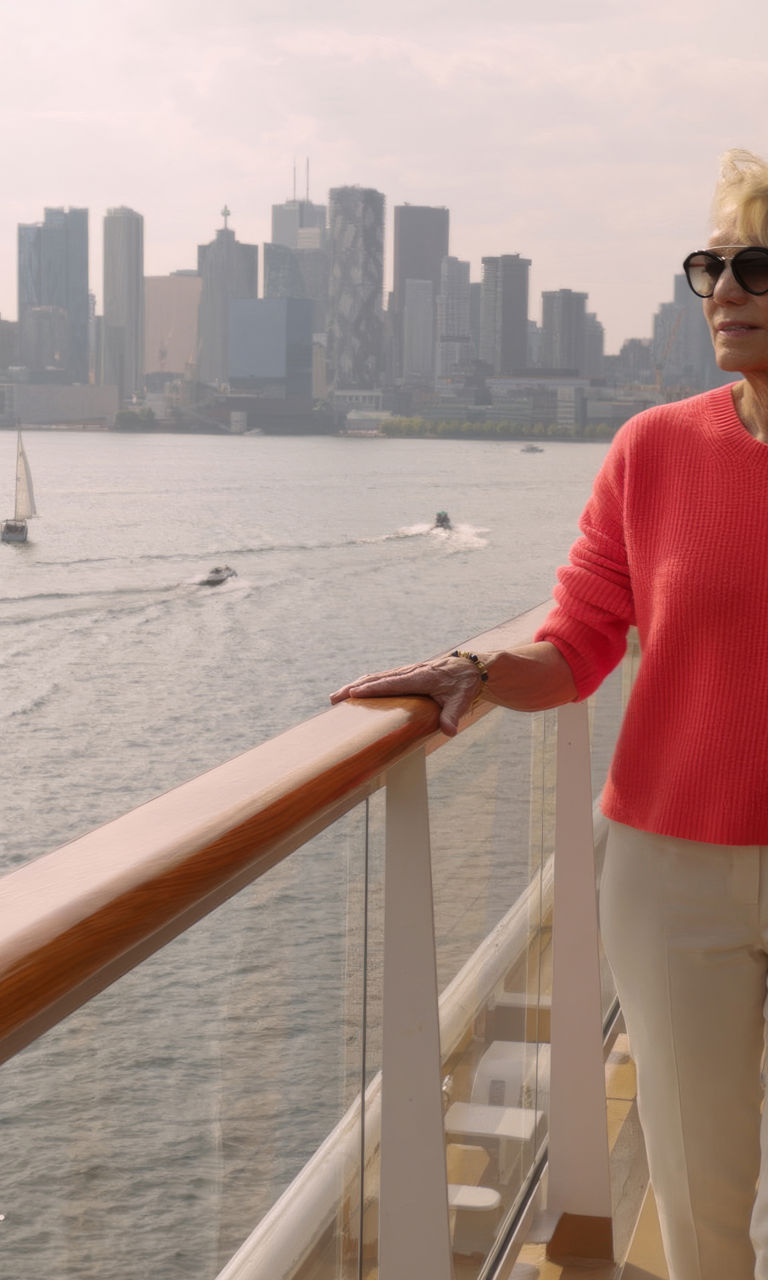 Woman on cruise ship with city skyline