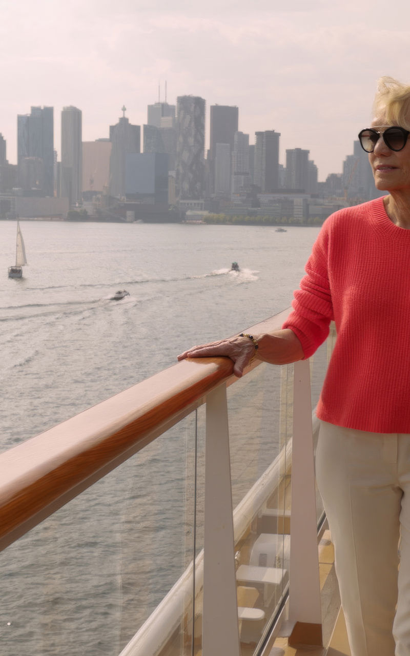 Woman on cruise ship with city skyline