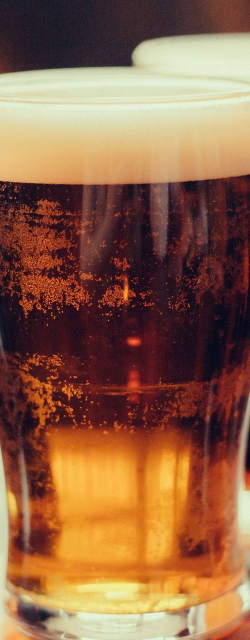Three glasses of beer on wooden table