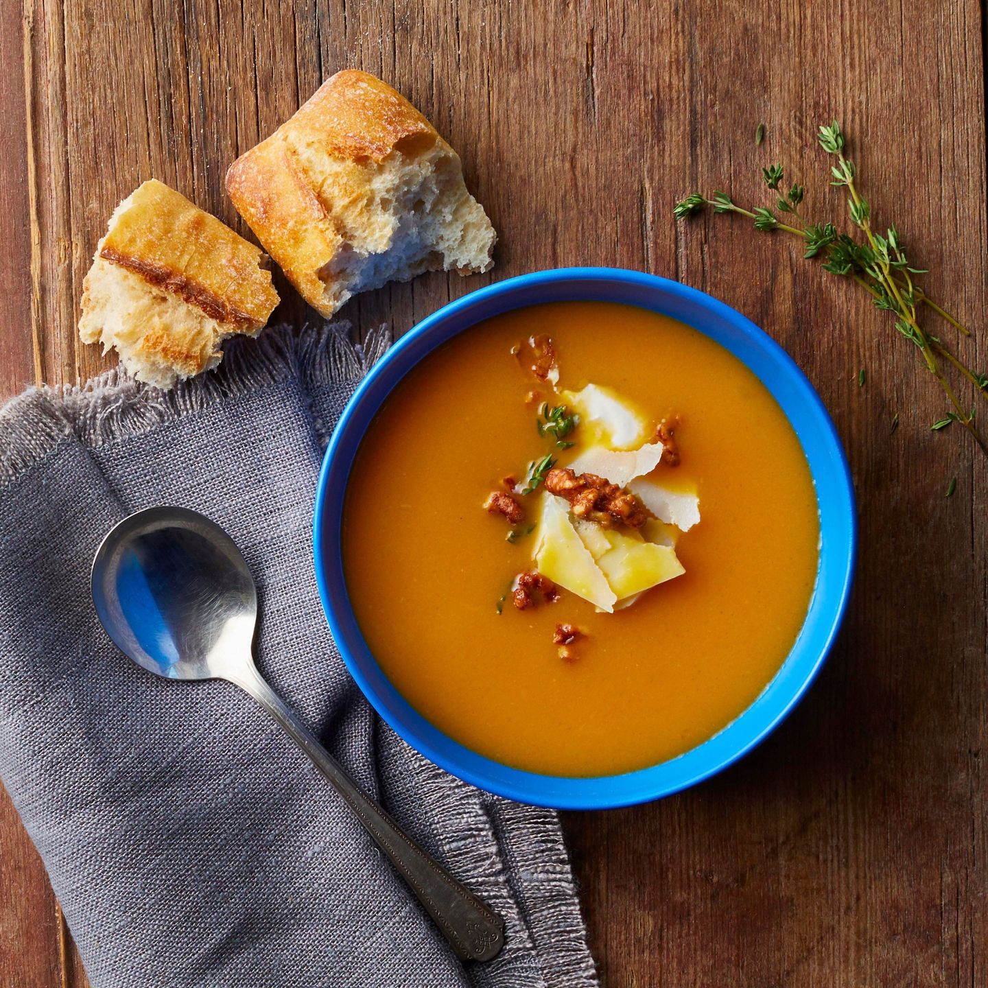 Rustic soup with bread on wooden table