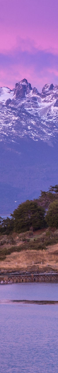 Snow-capped mountains under vibrant purple sky
