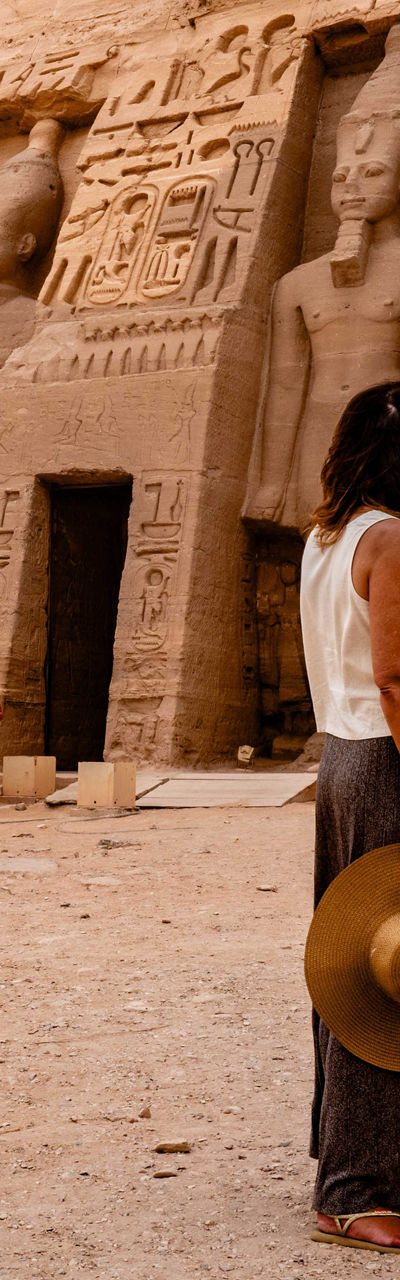 Tourists Explore Ancient Egyptian Temple with Statues
