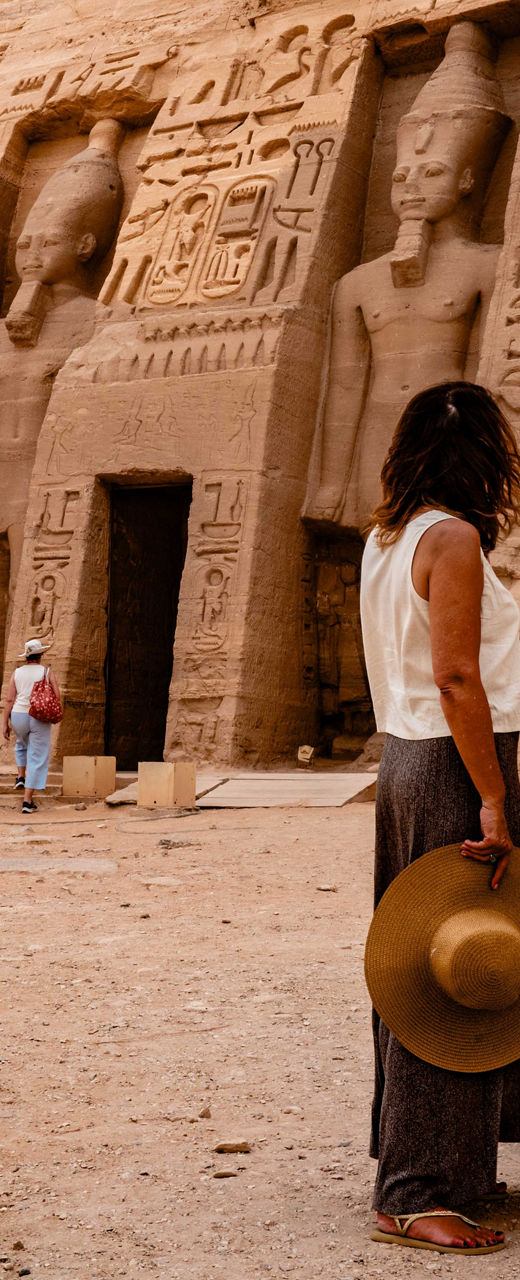 Tourists Explore Ancient Egyptian Temple with Statues