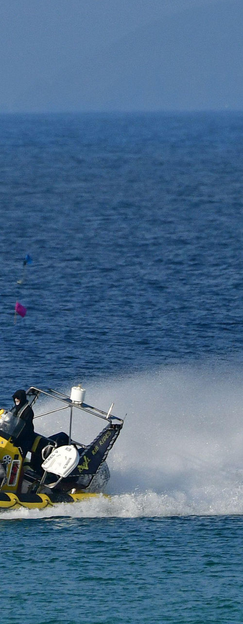 Yellow speedboat with passengers on open water