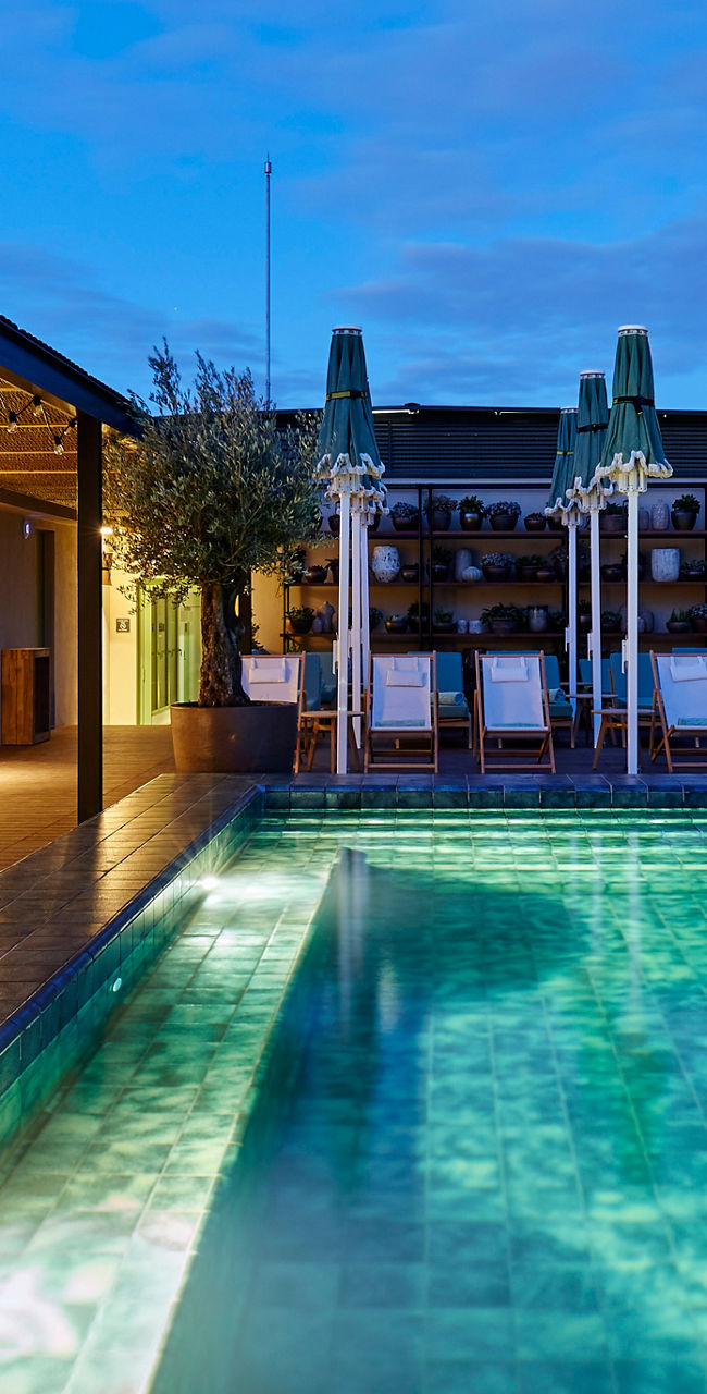Modern rooftop pool at sunset