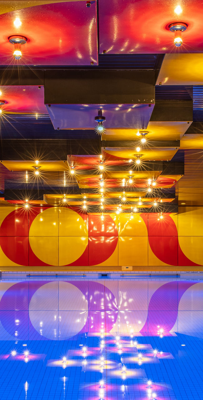 Modern indoor pool with vibrant lighting
