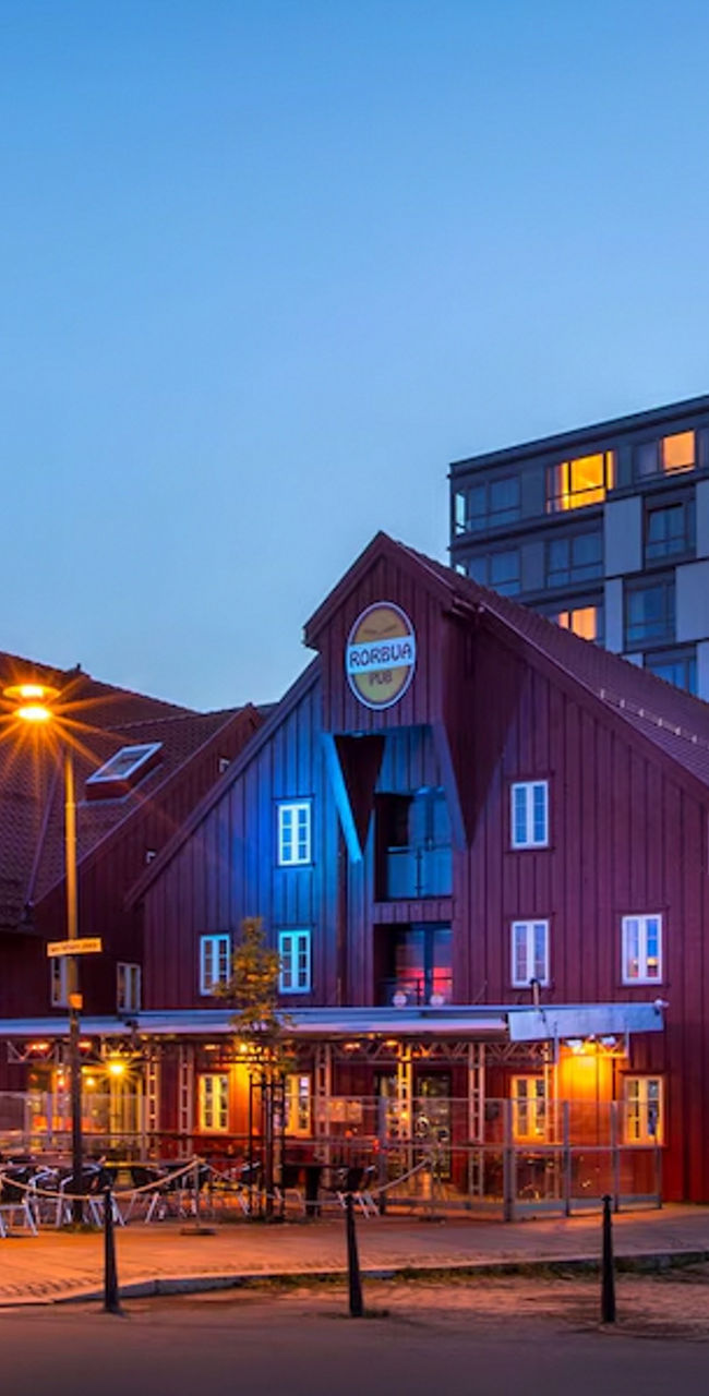 Modern hotel and rustic buildings at dusk