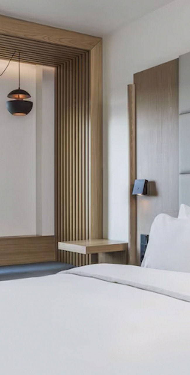 Modern hotel room with desk and window view