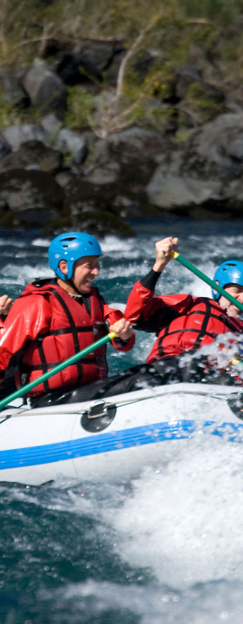 Group whitewater rafting on turbulent river