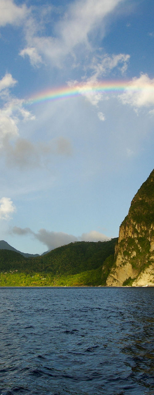 Rainbow over tropical mountain and ocean