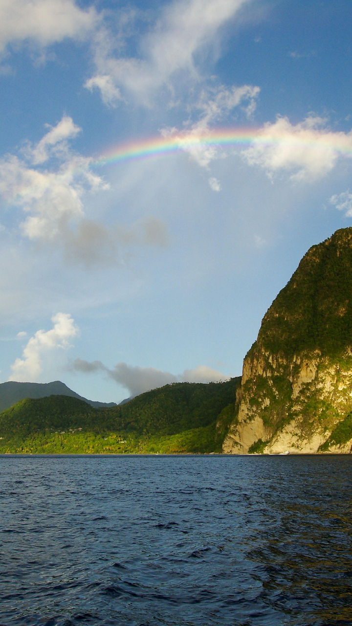 Rainbow over tropical mountain and ocean