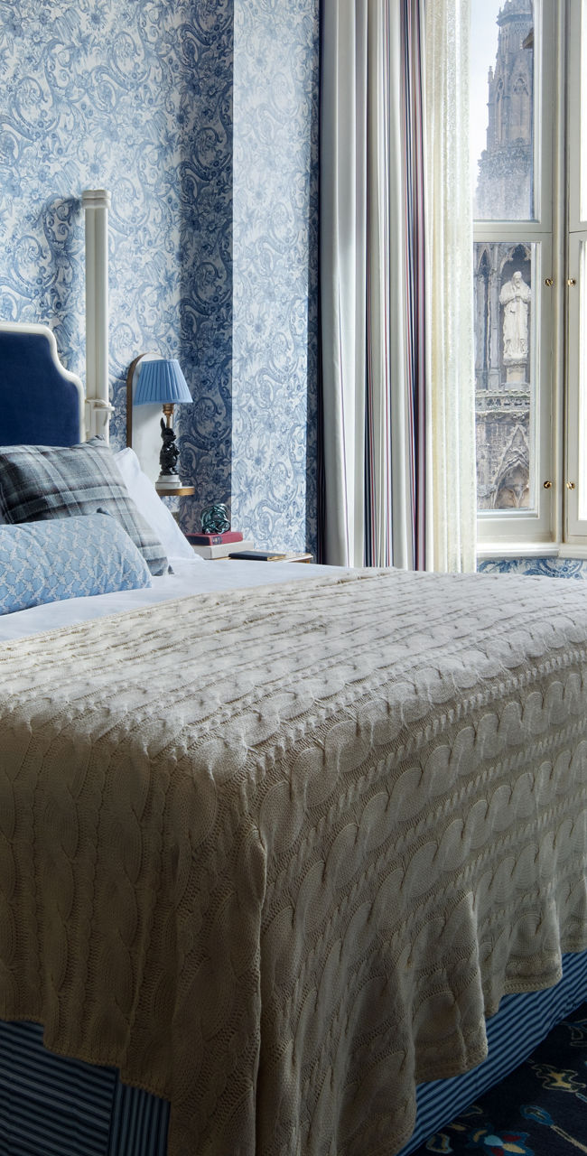 Elegant blue patterned hotel room with large window