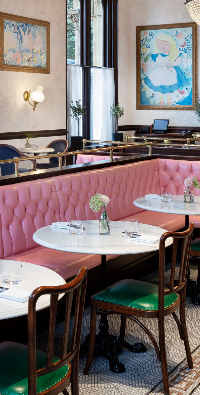 Elegant restaurant interior with chandeliers and pink seating