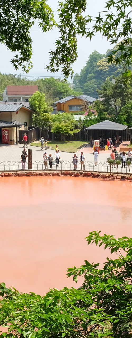 Tourists at scenic red hot spring pond