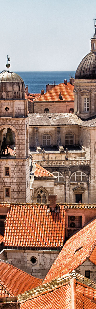 Historic rooftops with sea and domes