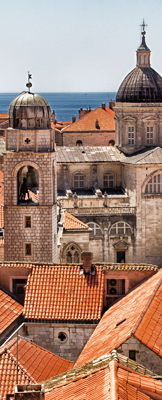 Historic rooftops with sea and domes