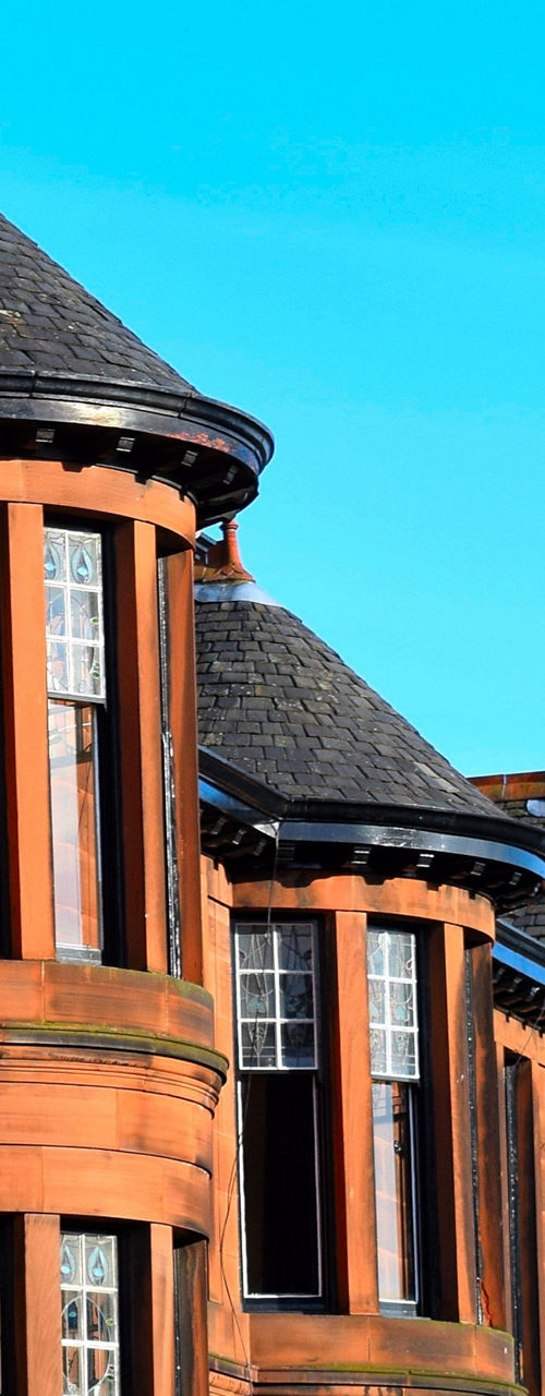 Historic red sandstone buildings in urban setting