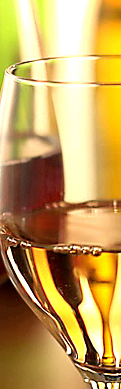 Red and white wine glasses in warm light